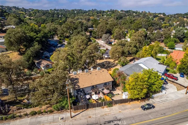 an aerial view of residential houses with outdoor space and street view