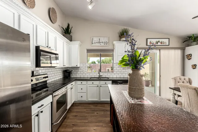 a kitchen with granite countertop a sink and stove top oven