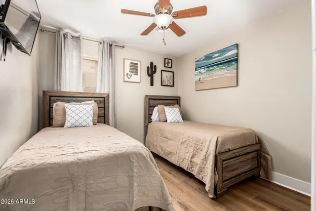 a bedroom with a bed and ceiling fan