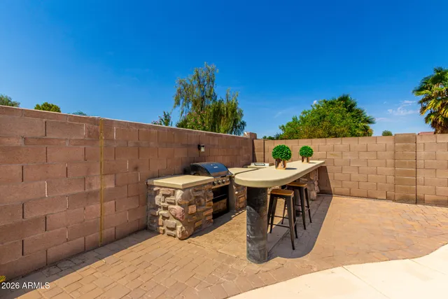 a roof deck with table and chairs