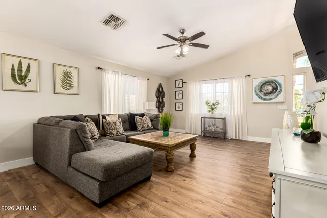 a living room with furniture and wooden floor