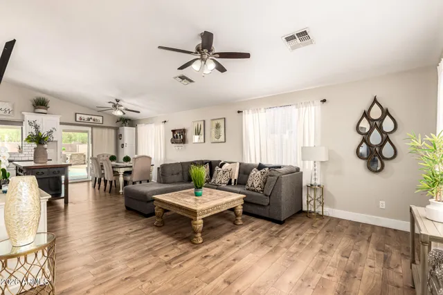 a living room with furniture and wooden floor