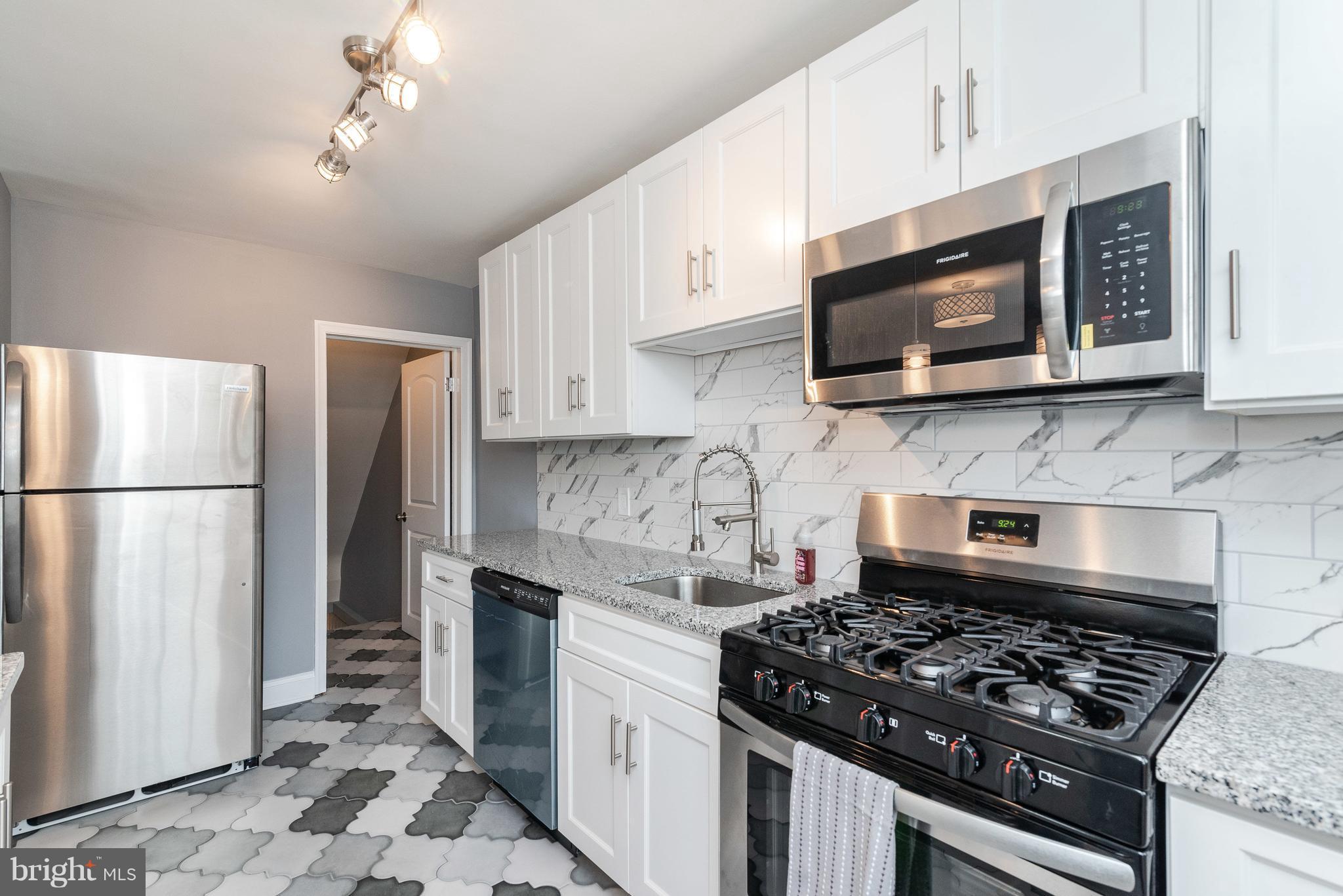 700 Aldworth Road Baltimore, MD 21222 - Photo 12 of 30 a kitchen with stainless steel appliances granite countertop a stove sink microwave and refrigerator