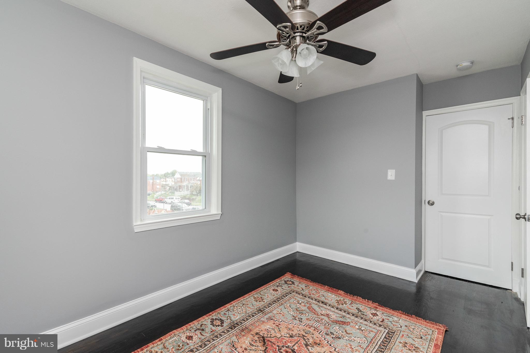700 Aldworth Road Baltimore, MD 21222 - Photo 16 of 30 a view of an empty room with a window and wooden floor