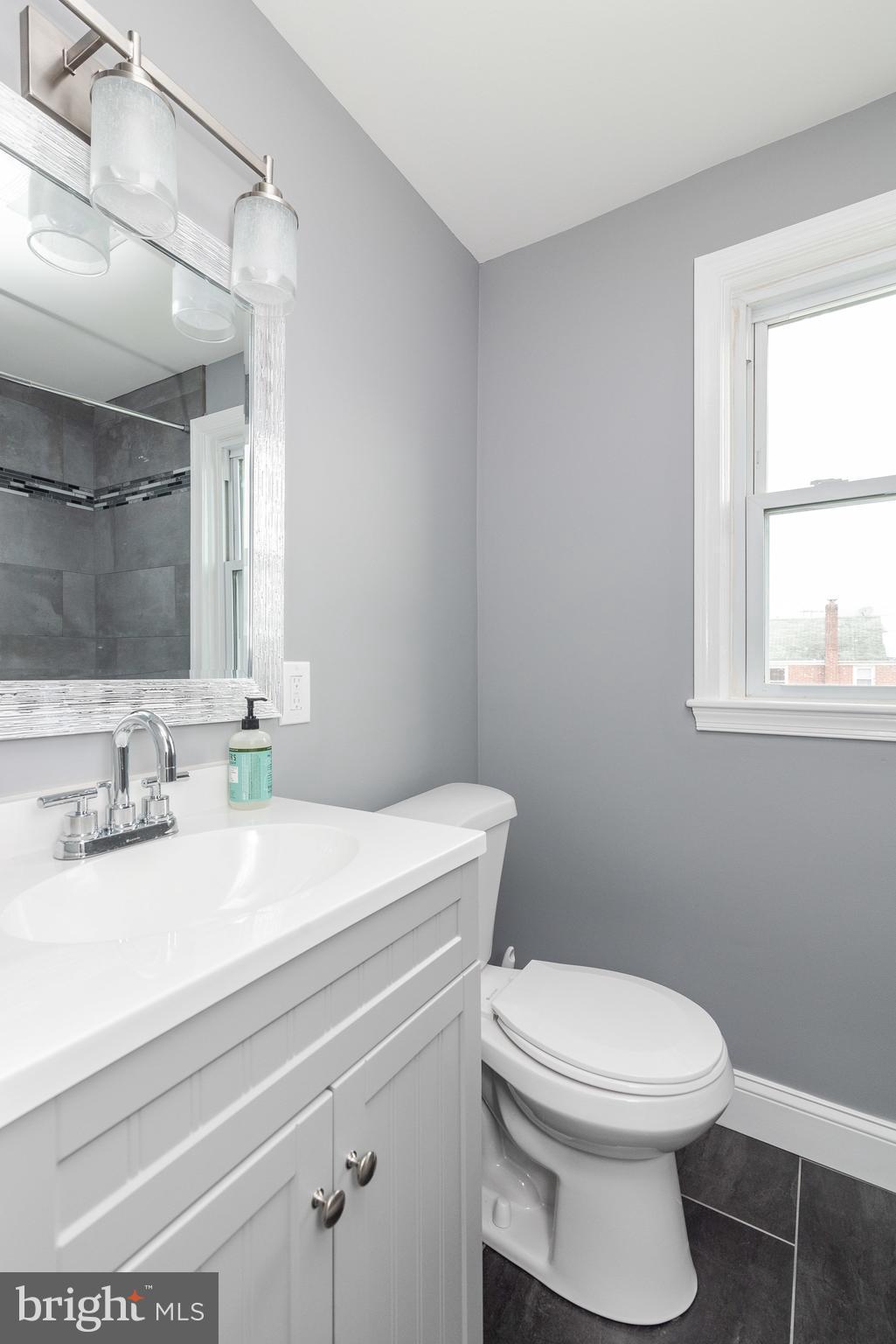 700 Aldworth Road Baltimore, MD 21222 - Photo 17 of 30 a bathroom with a sink a toilet and a mirror