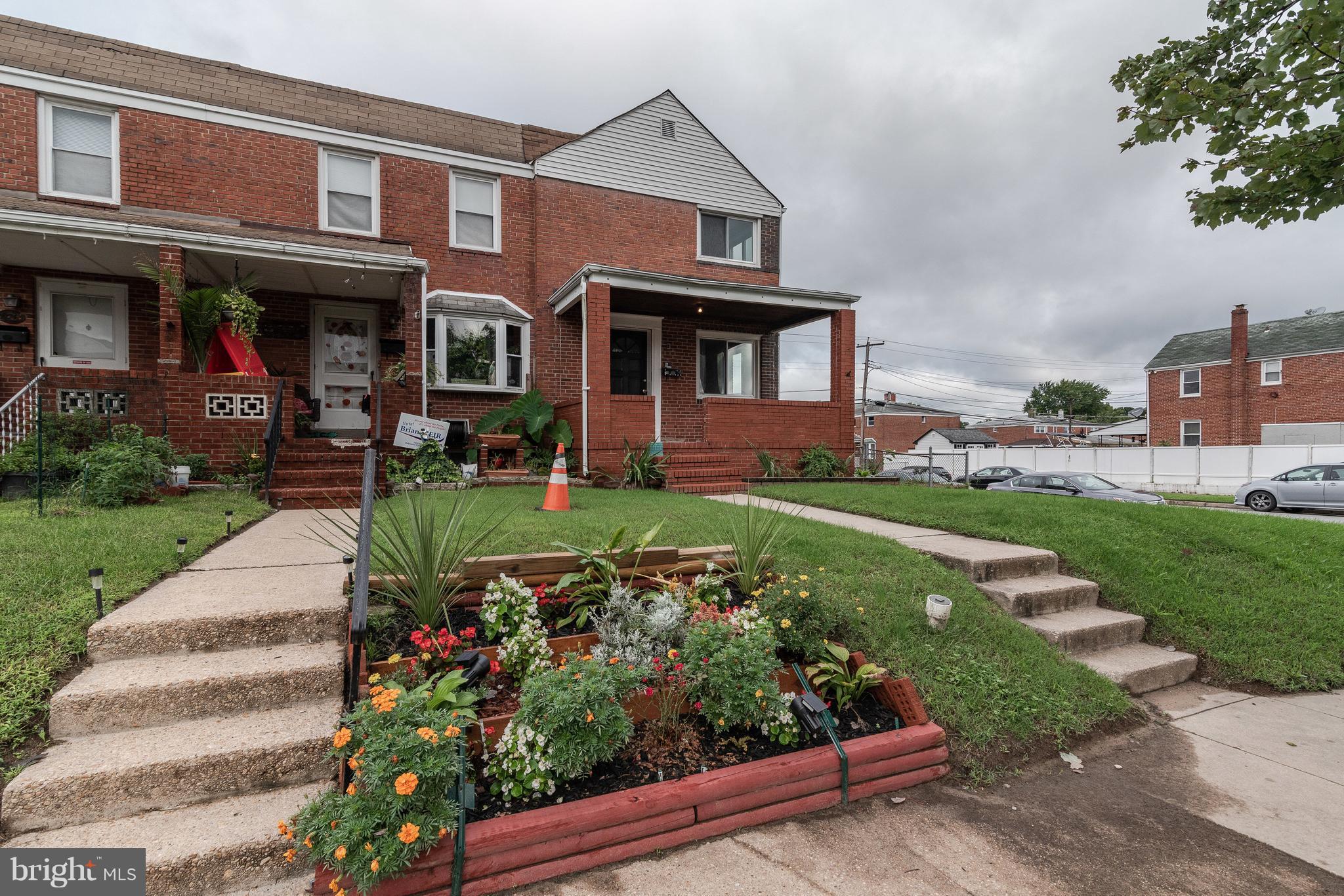 700 Aldworth Road Baltimore, MD 21222 - Photo 25 of 30 front view of a brick house with a yard