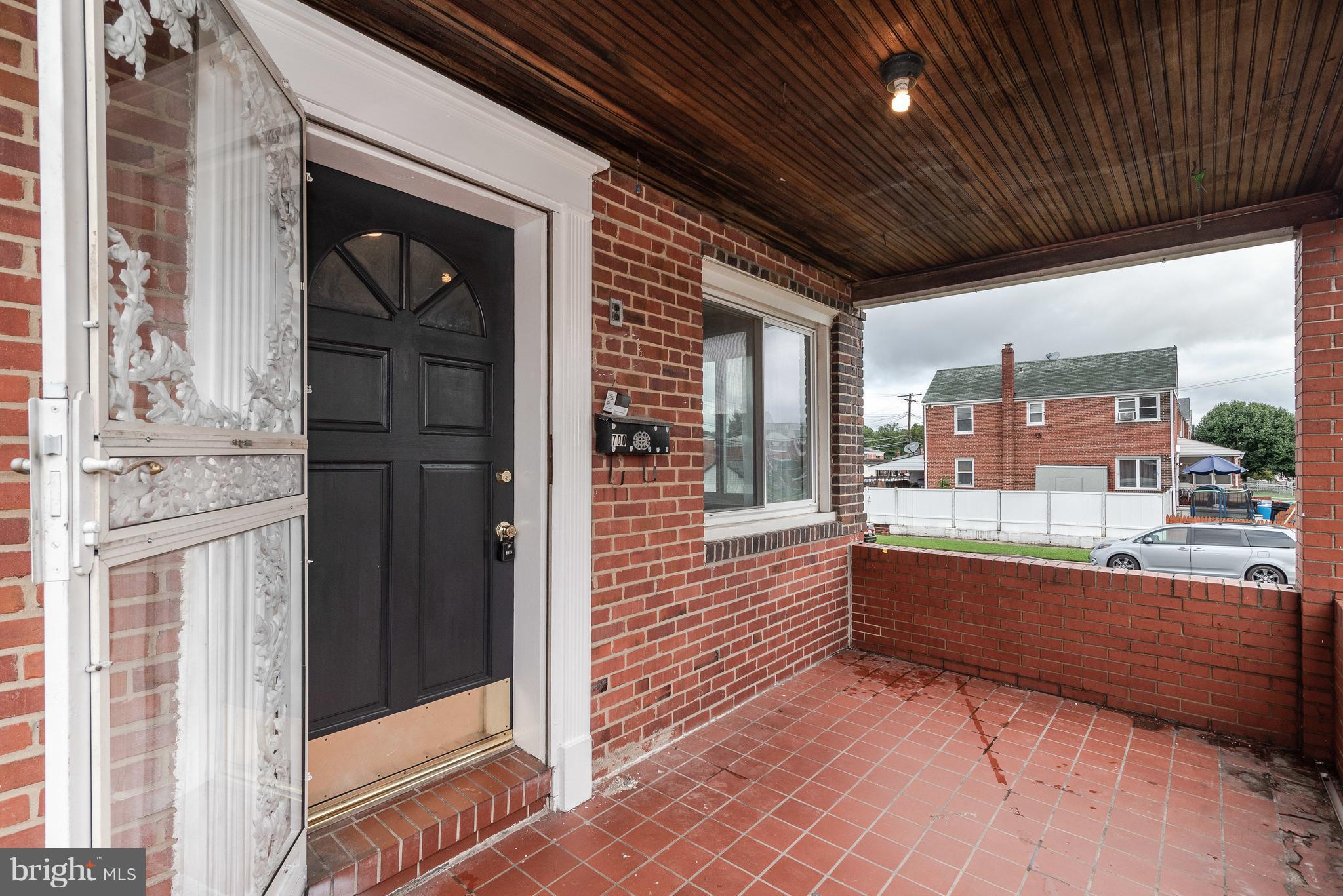 700 Aldworth Road Baltimore, MD 21222 - Photo 29 of 30 a view of porch with a table and chairs