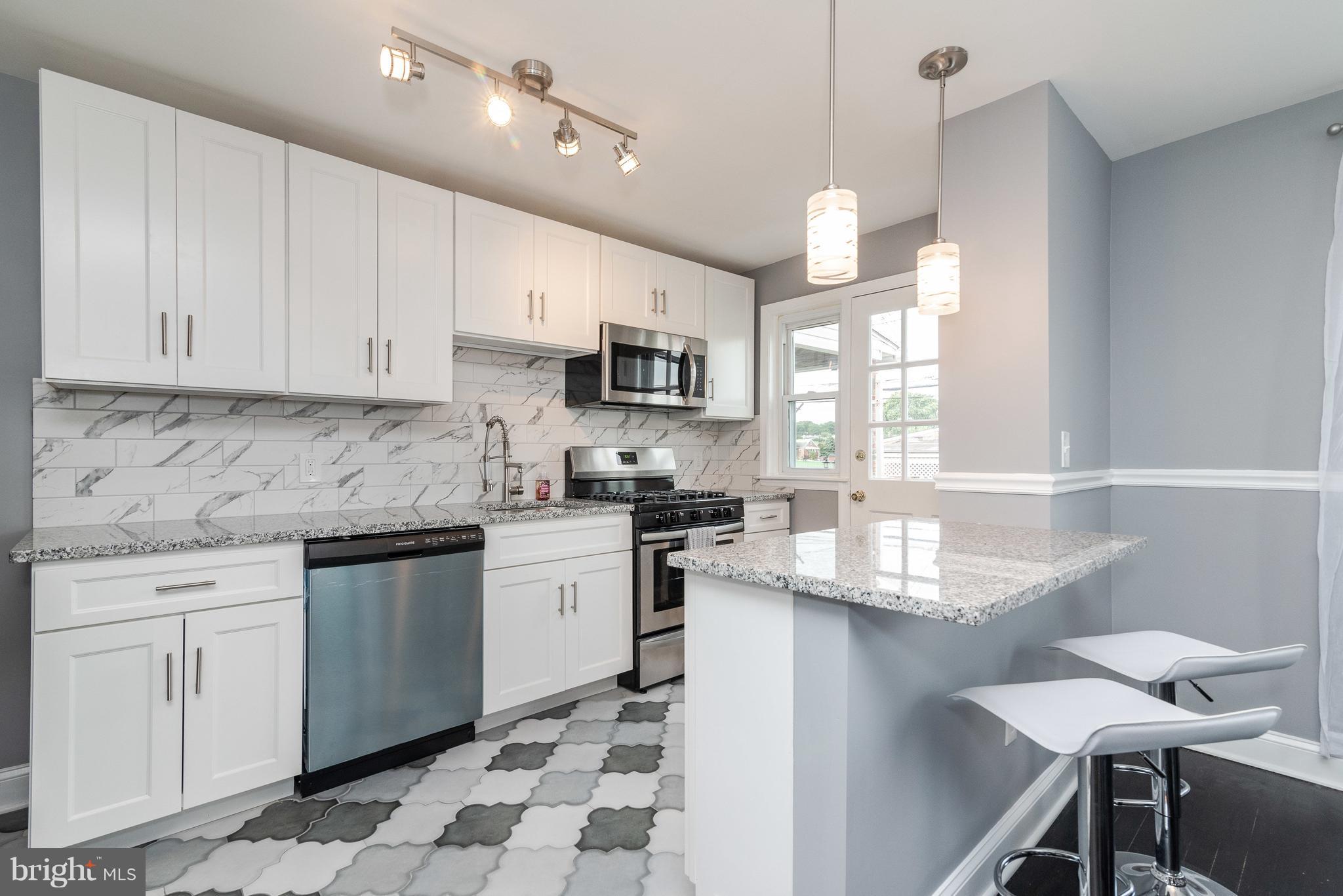 700 Aldworth Road Baltimore, MD 21222 - Photo 8 of 30 a kitchen with granite countertop a sink window and cabinets