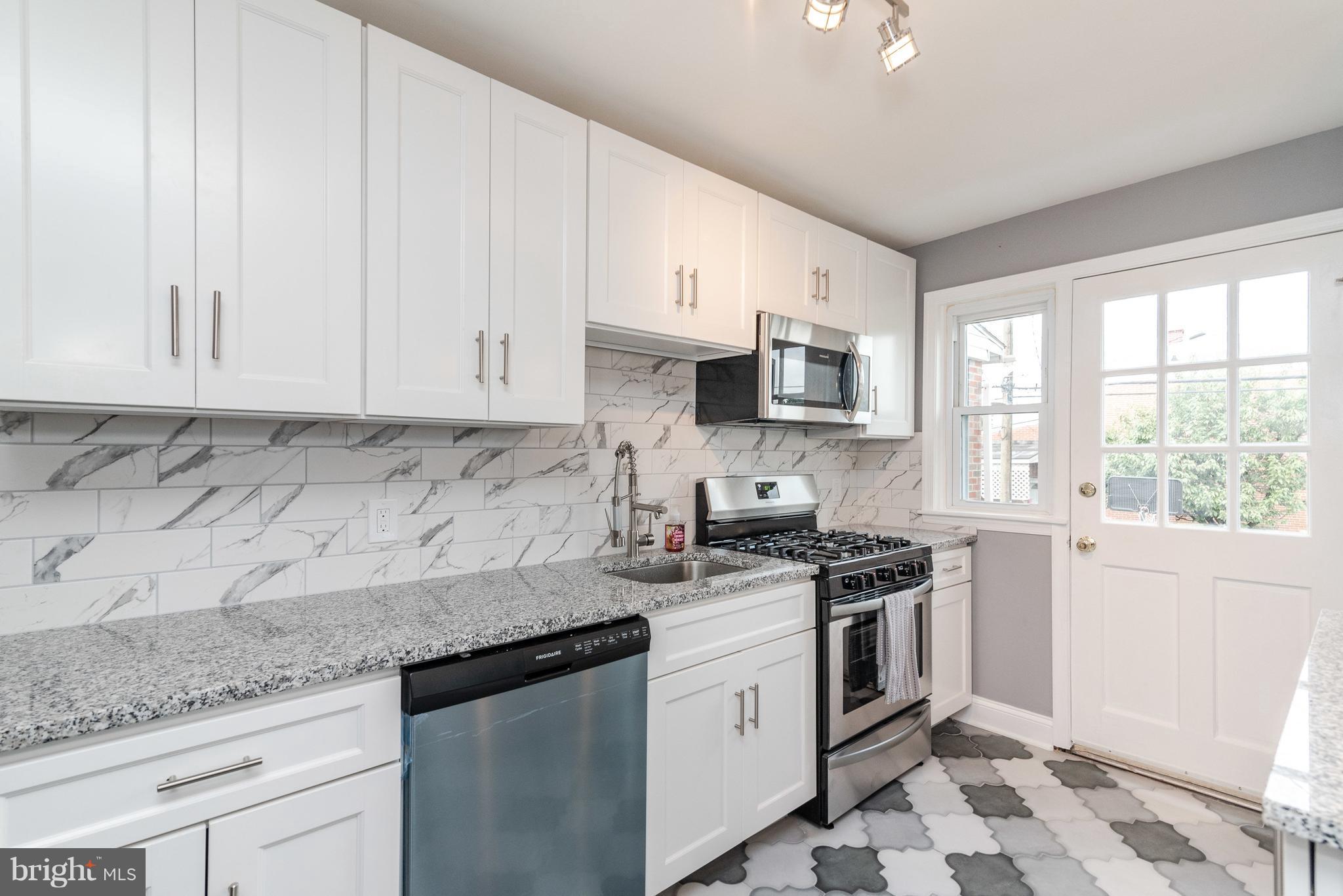700 Aldworth Road Baltimore, MD 21222 - Photo 9 of 30 a kitchen with stainless steel appliances granite countertop white cabinets granite counter tops and a window