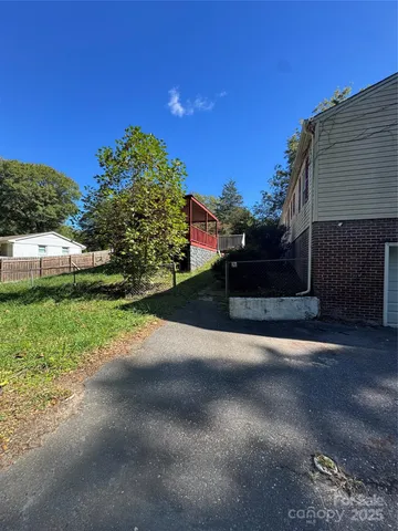 a view of a street with a house in the background