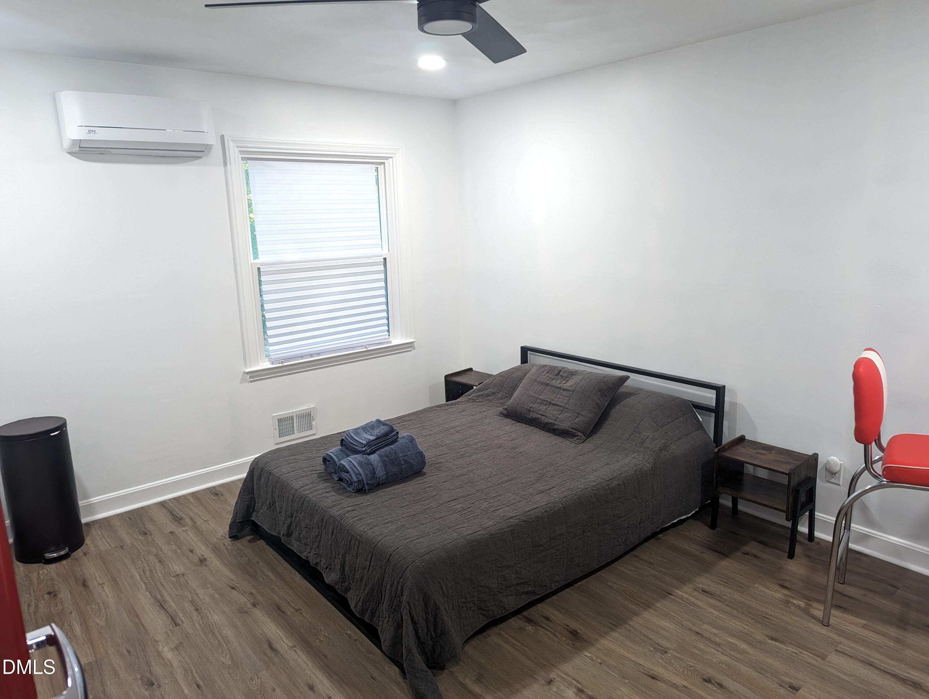 4816 Whitehall Avenue Raleigh, NC 27604 - Photo 23 of 23 a bedroom with a bed and wooden floor