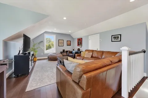 a living room with furniture a large window and a flat screen tv