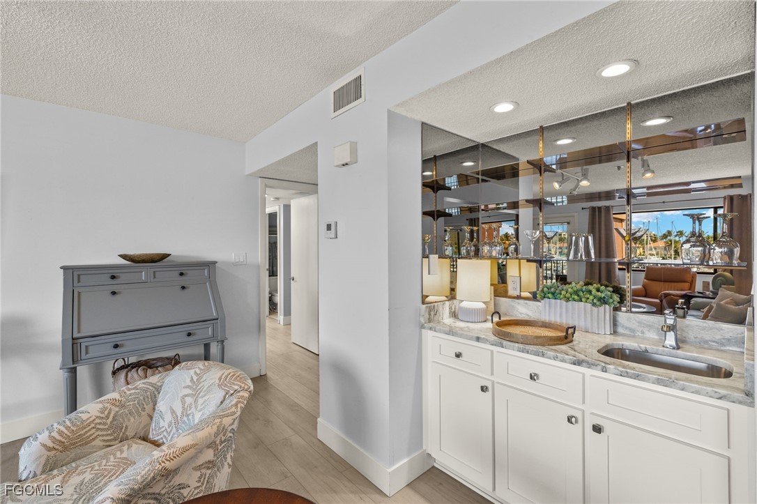 3170 Matecumbe Key Road, Unit 134 Punta Gorda, FL 33955 - Photo 14 of 31 a spacious bathroom with a double vanity sink and mirror