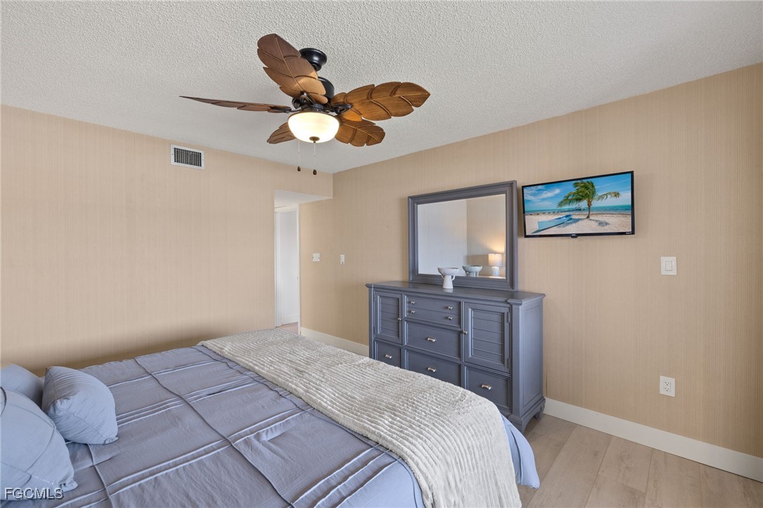 3170 Matecumbe Key Road, Unit 134 Punta Gorda, FL 33955 - Photo 18 of 31 a bedroom with a bed and cabinets