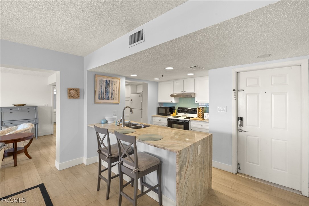 3170 Matecumbe Key Road, Unit 134 Punta Gorda, FL 33955 - Photo 9 of 31 a kitchen with a table and chairs in it