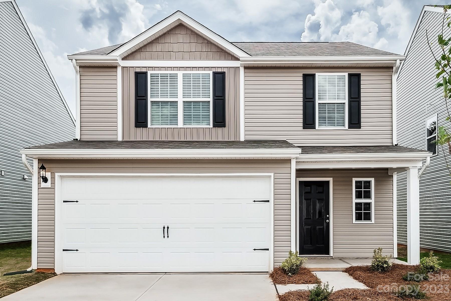 1341 Nia Road Charlotte, NC 28215 - Photo 1 of 15 a front view of a house with a garage