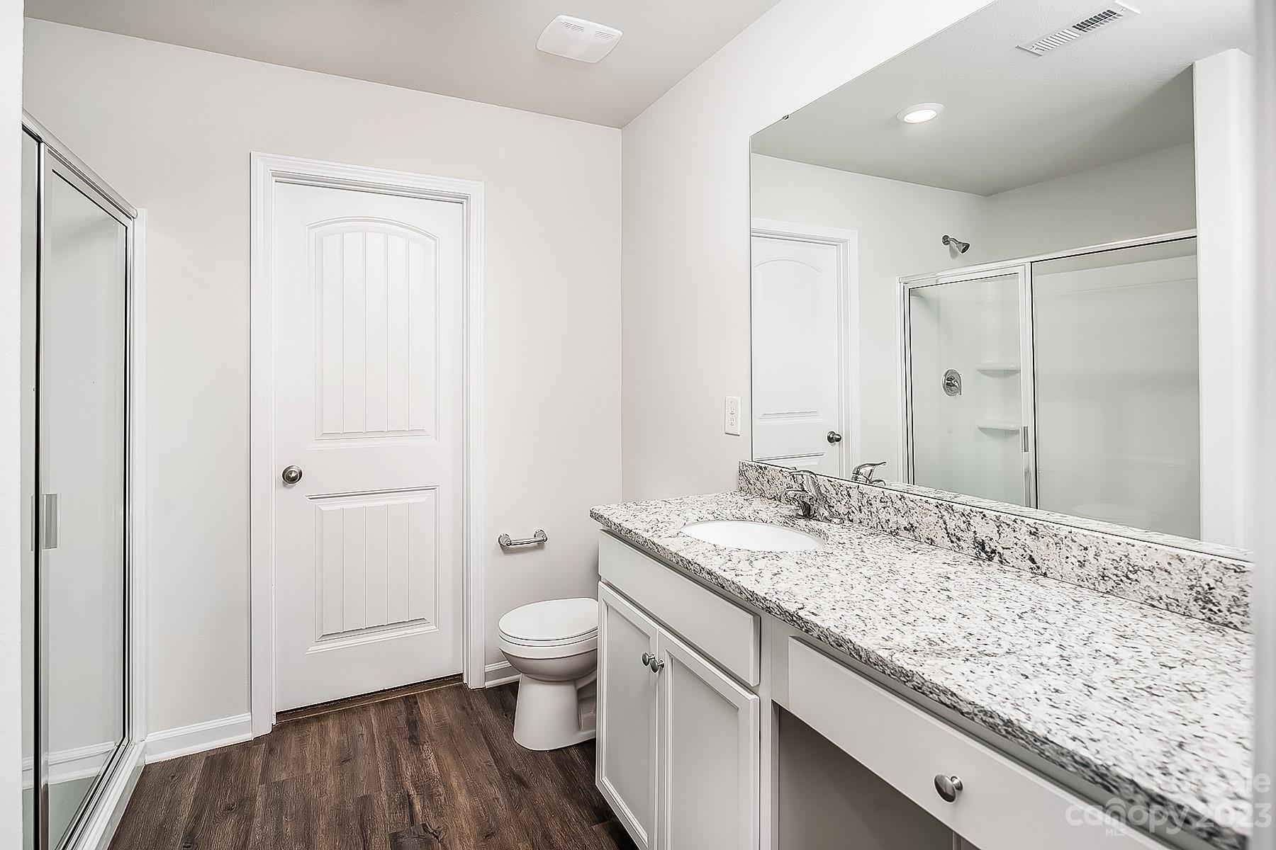 1341 Nia Road Charlotte, NC 28215 - Photo 12 of 15 a bathroom with a granite countertop sink and a mirror
