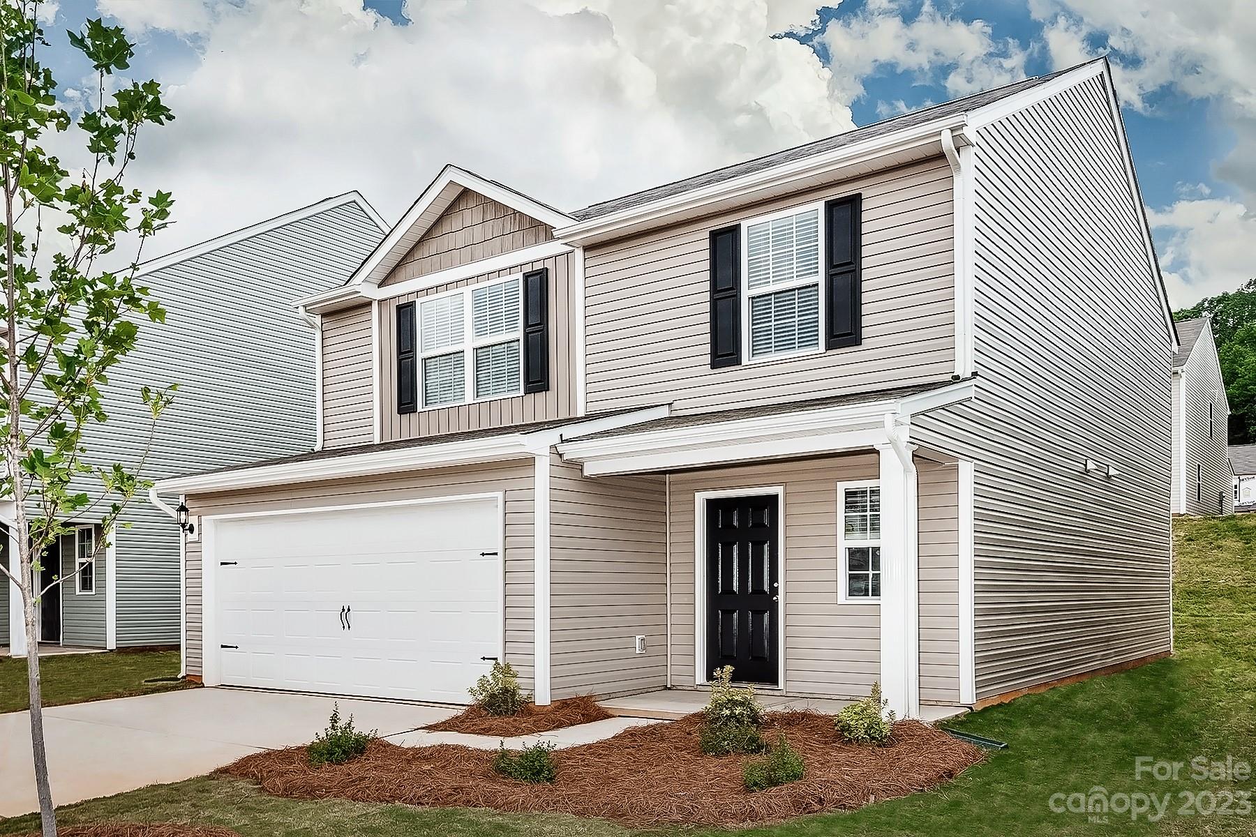 1341 Nia Road Charlotte, NC 28215 - Photo 2 of 15 a view of a house with white walls and a tree