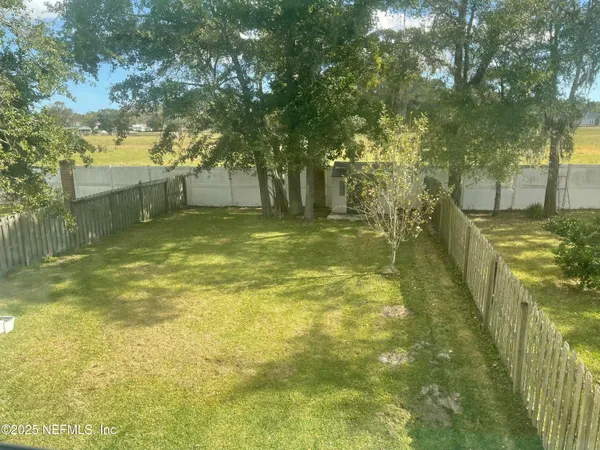 a view of a yard with swimming pool