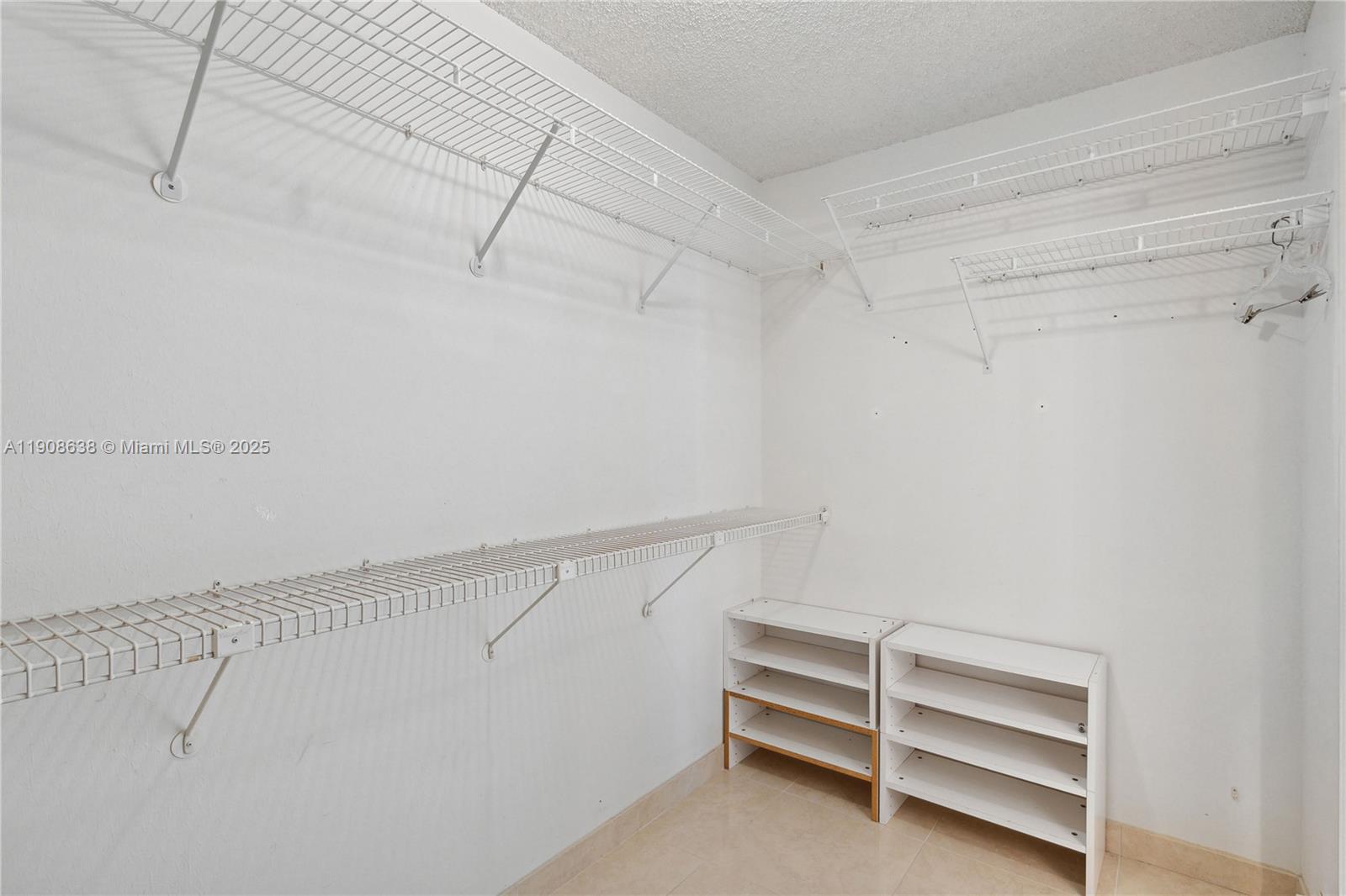 1901 Brickell Avenue, Unit B1408 Miami, FL 33129 - Photo 14 of 37 a view of walk in closet with empty racks