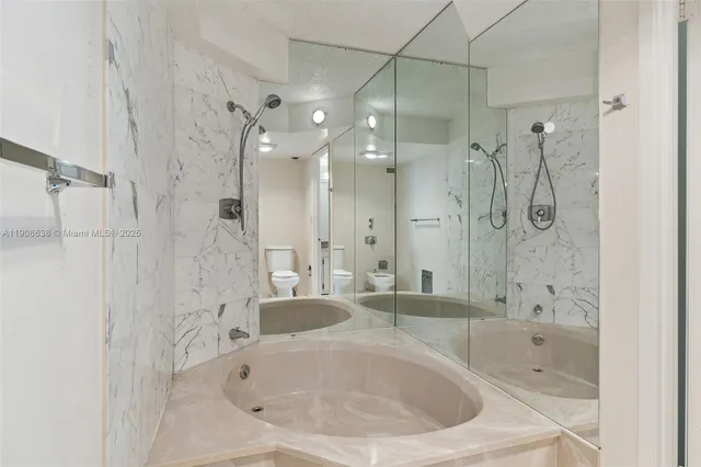 a bathroom with a granite countertop sink a toilet and a mirror