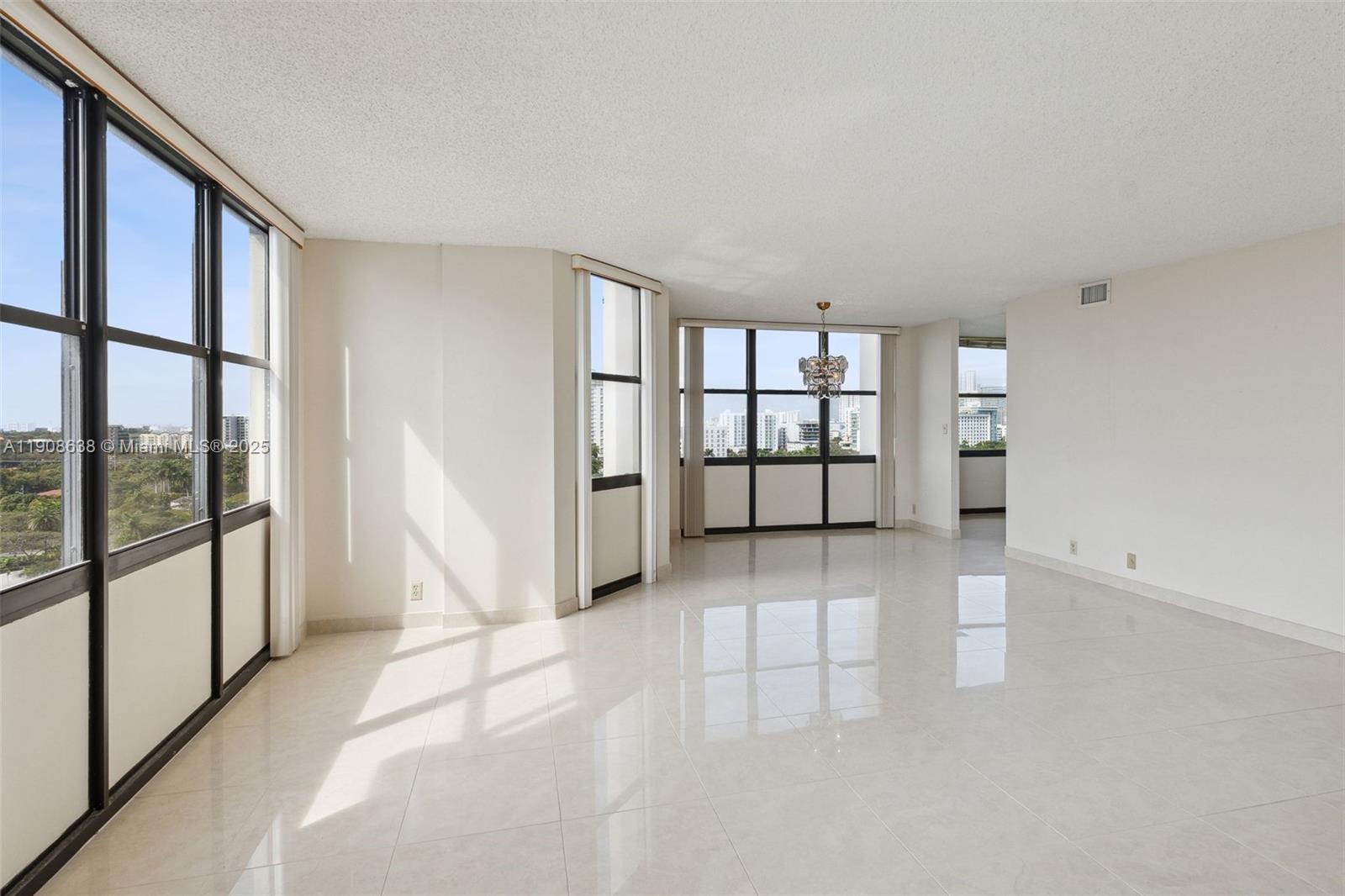1901 Brickell Avenue, Unit B1408 Miami, FL 33129 - Photo 21 of 37 an empty room with windows and stairs