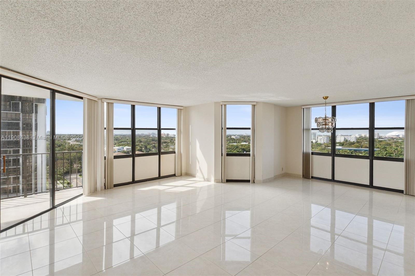 1901 Brickell Avenue, Unit B1408 Miami, FL 33129 - Photo 5 of 37 a view of an empty room with window and chandelier