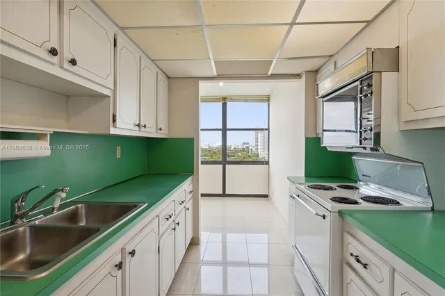 a kitchen with a sink cabinets and window