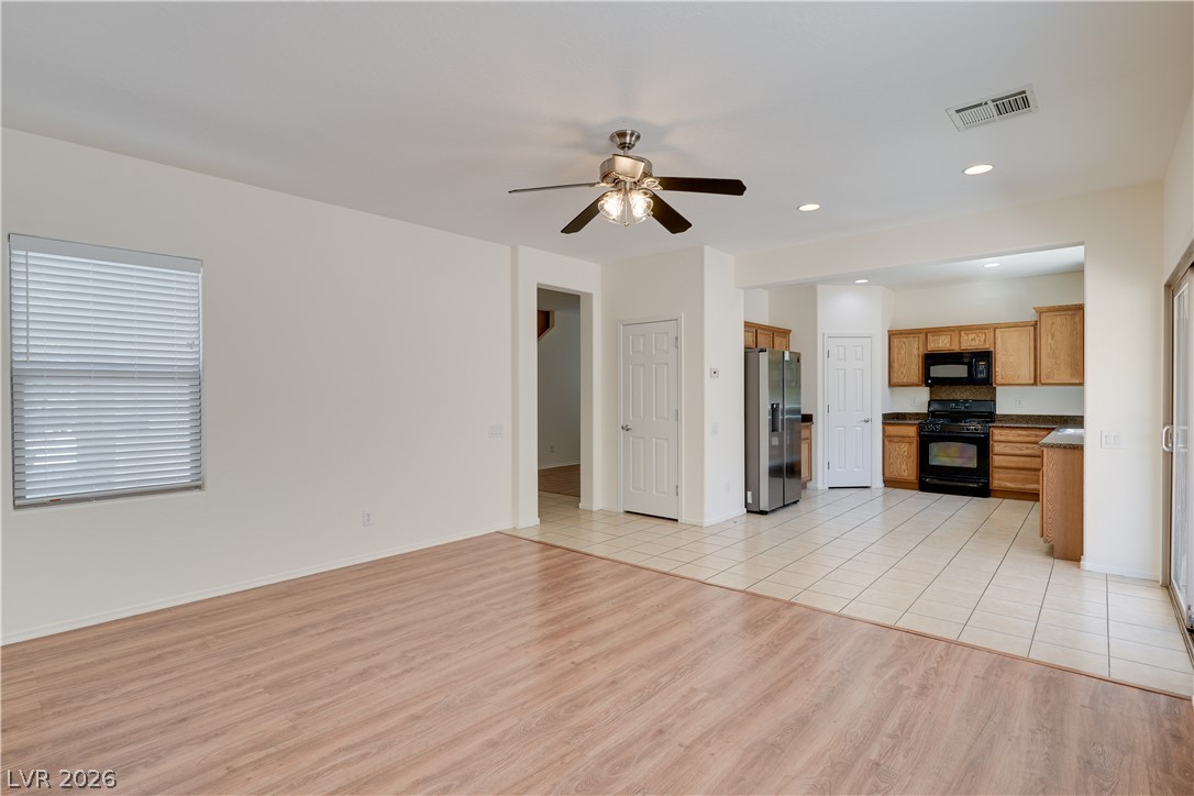2717 Rimbaud Street Henderson, NV 89044 - Photo 34 of 34 An open floor plan seamlessly connects the living area with a well-appointed kitchen, ideal for effortless entertaining.