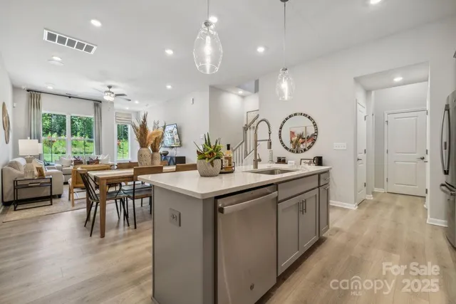 a kitchen with a table chairs sink and cabinets