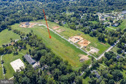 an aerial view of a residential houses with outdoor space and street view