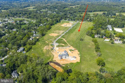 an aerial view of a residential houses with yard