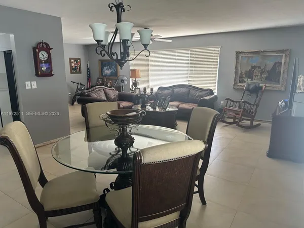 a dining room with furniture and window