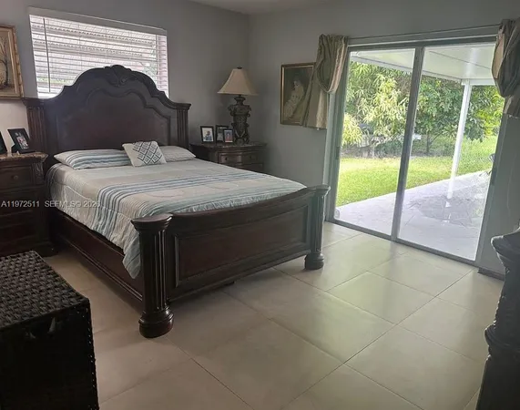 a bedroom with a bed and glass door