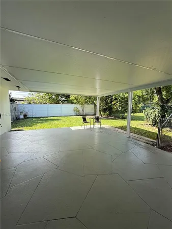a view of a swimming pool with an outdoor space and seating area