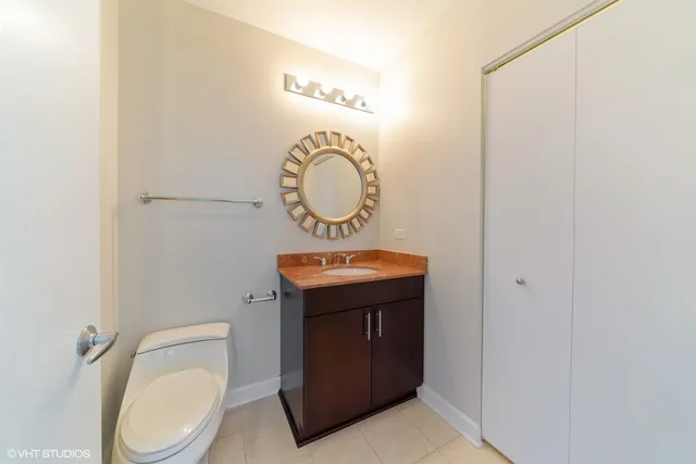 a bathroom with a toilet a sink and a mirror