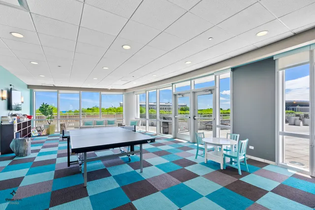 a room with pool table and windows