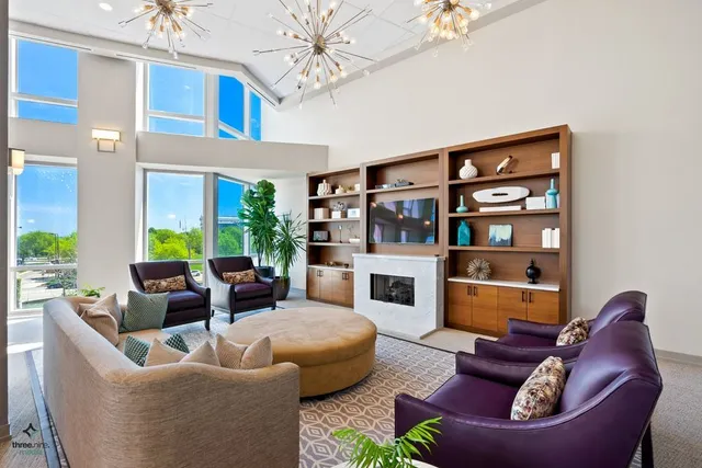 a living room with furniture fireplace and a chandelier