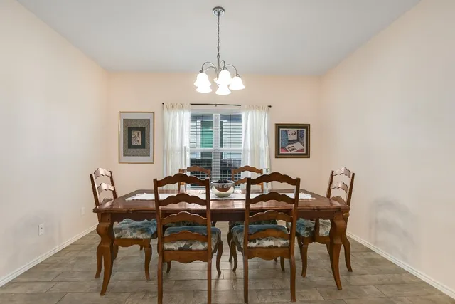 a view of a dining room with furniture and chandelier