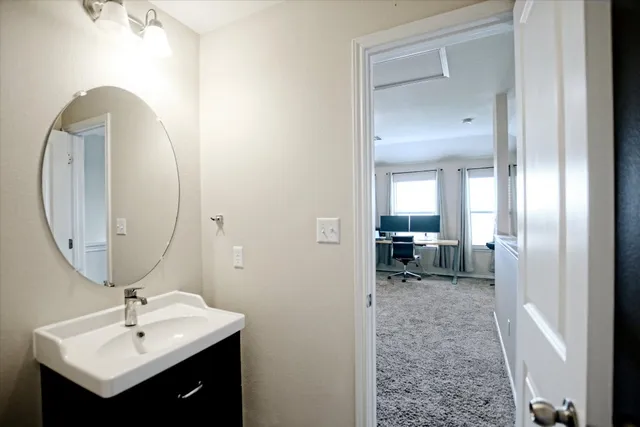 a en suite bathroom with a sink and a mirror
