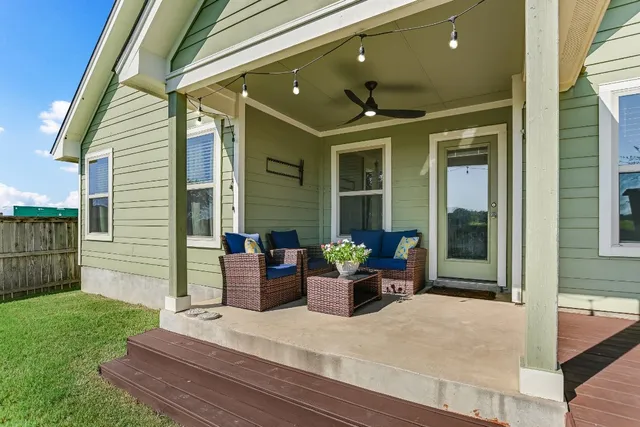 a view of a patio with couches chairs and potted plants