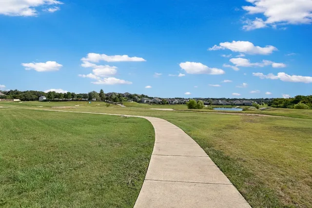 a view of a lake with houses in the background