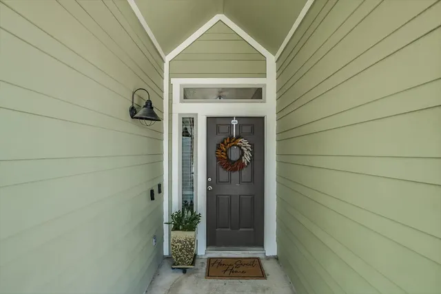 a view of a door and a window of the house
