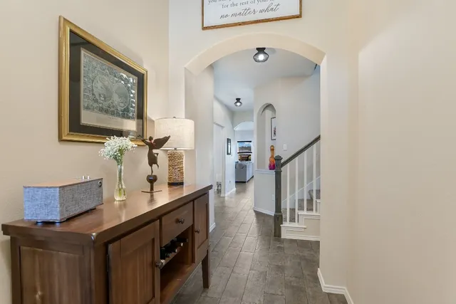 a hall way with furniture and paintings on the wall