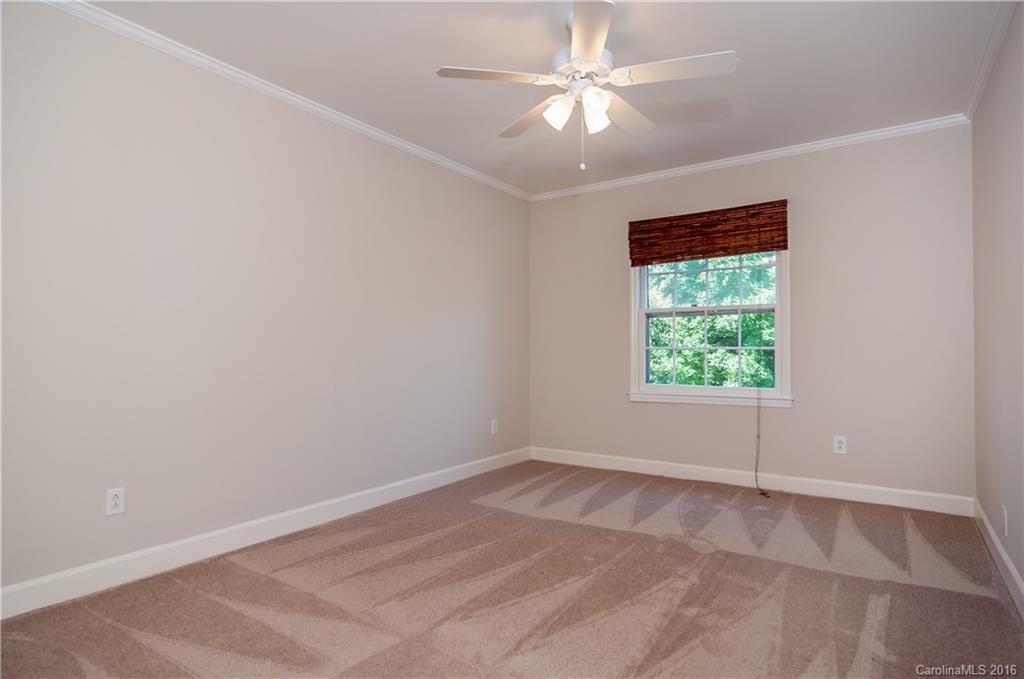 5945 Quail Hollow Road, Unit A Charlotte, NC 28210 - Photo 12 of 19 an empty room with a window and a fan