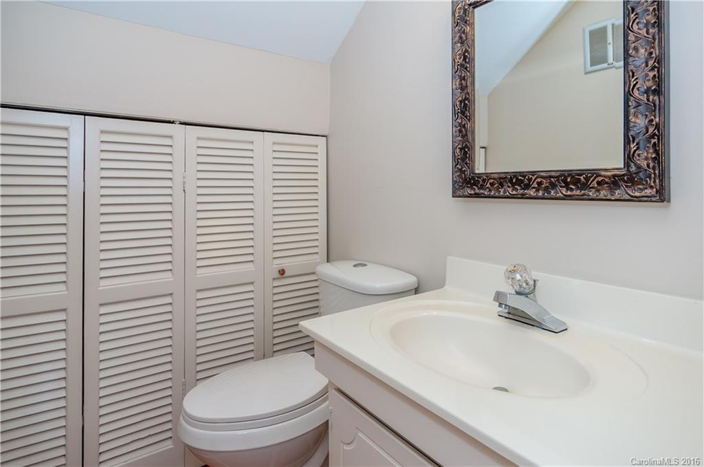 5945 Quail Hollow Road, Unit A Charlotte, NC 28210 - Photo 14 of 19 a bathroom with a toilet a sink and a window