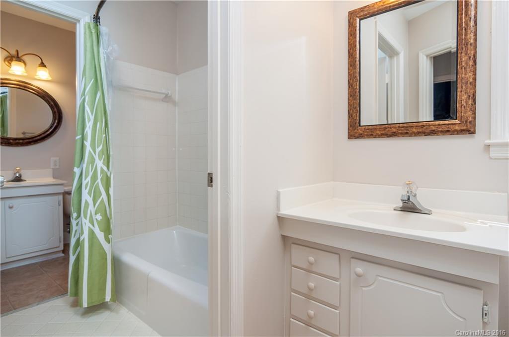 5945 Quail Hollow Road, Unit A Charlotte, NC 28210 - Photo 15 of 19 a bathroom with a sink and a mirror