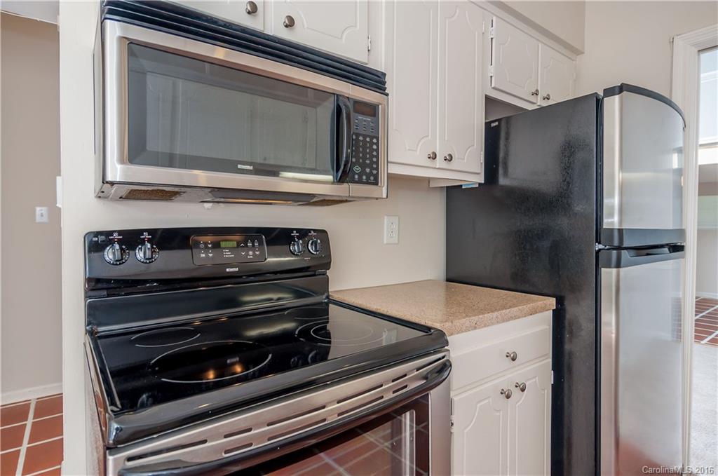 5945 Quail Hollow Road, Unit A Charlotte, NC 28210 - Photo 8 of 19 a kitchen with stainless steel appliances a stove a microwave and a refrigerator