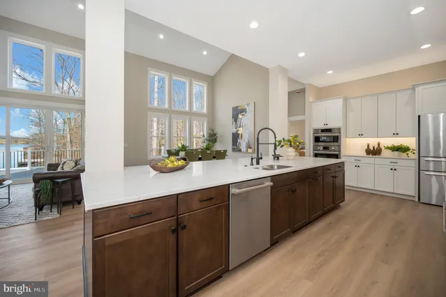 a kitchen with granite countertop white cabinets and stainless steel appliances