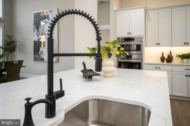 a spacious bedroom with a bed and a chandelier